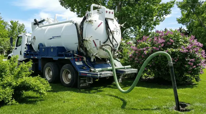 Professional vacuum truck performing residential drainage and septic maintenance in Staten Island, NY
