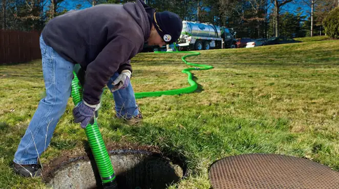 Service technician performing residential septic pumping and drainage maintenance in Staten Island, NY
